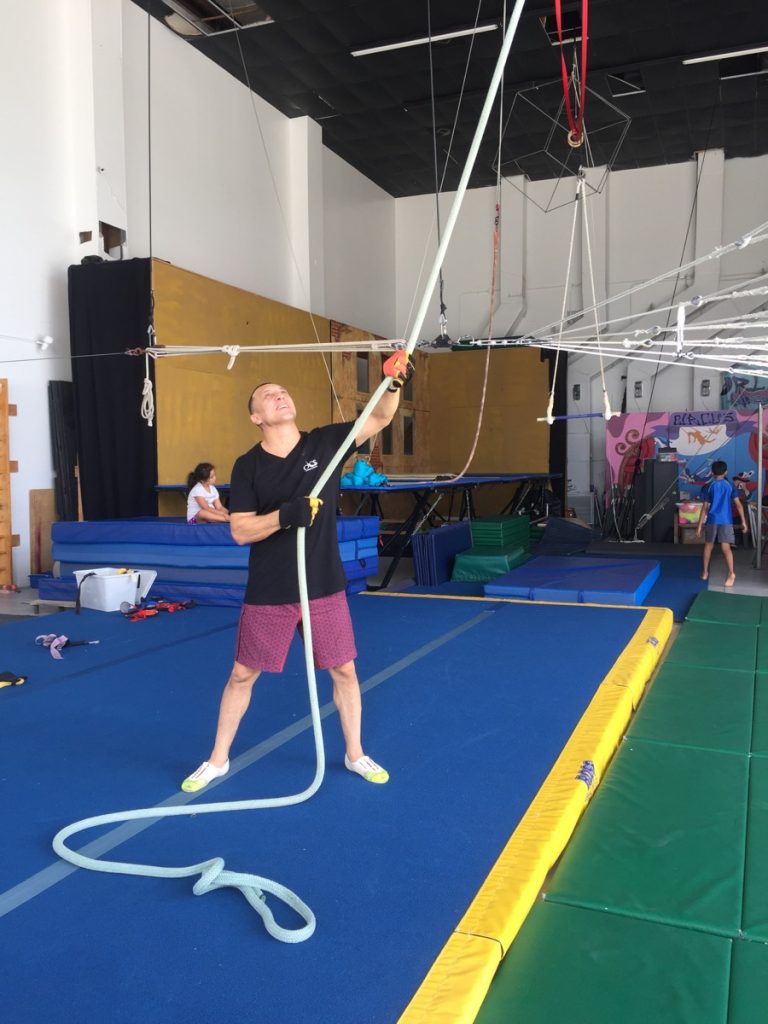 Coach rigging the flying trapeze at circus camp